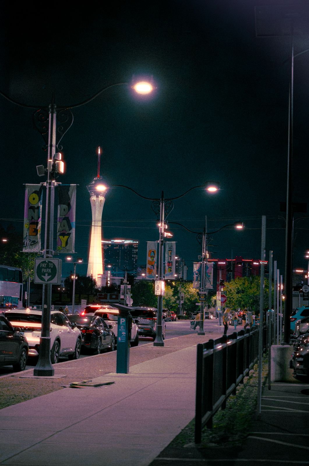 Las Vegas street at night with the Strat tower in the distance